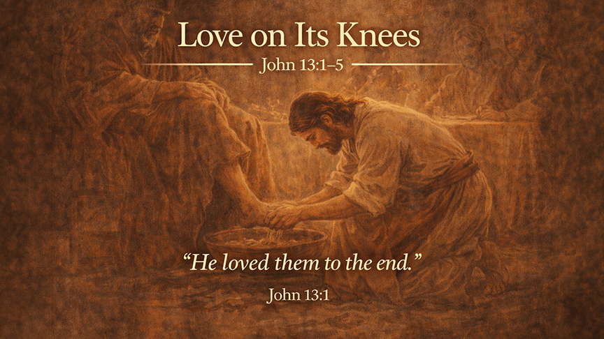 Love on Its Knees — A wide 16:9 photo-realistic image of Jesus kneeling to wash His disciples’ feet in a softly lit upper room. 